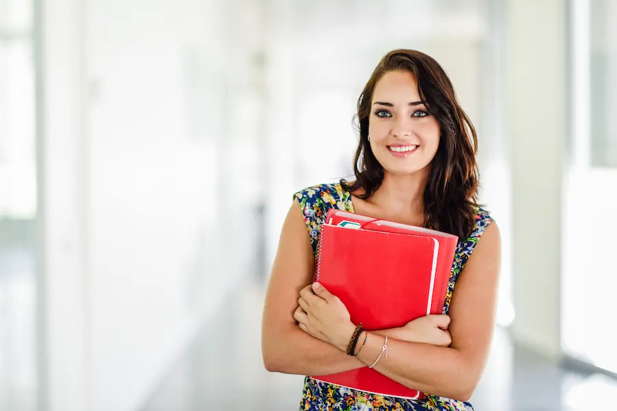 studentka z zeszytami. kontynuuje studia na kierunku administracja